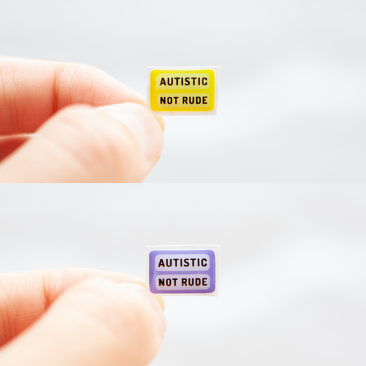 A sticker with the message 'Autistic Not Rude' designed for name badges and ID tags. A high-quality autistic sticker with your choice of a yellow or lavender background! Proudly say, I have autism!
