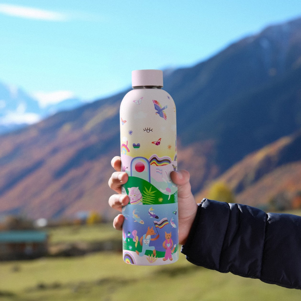 Badgie Be Yourself Steel Water Bottle BPAFree. Product image of a person holding the steel bottle brafree outdoors, on an adventure, hiking and fitness.