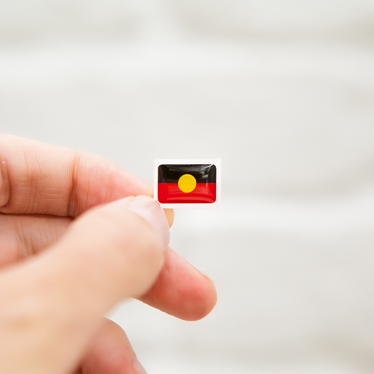 Badgie Aboriginal Flag Sticker. Always Was Always Will Be Aboriginal Land - Bright, durable sticker designed for name badges and ID tags, supporting Aboriginal and Torres Strait Islander peoples. Single sticker.