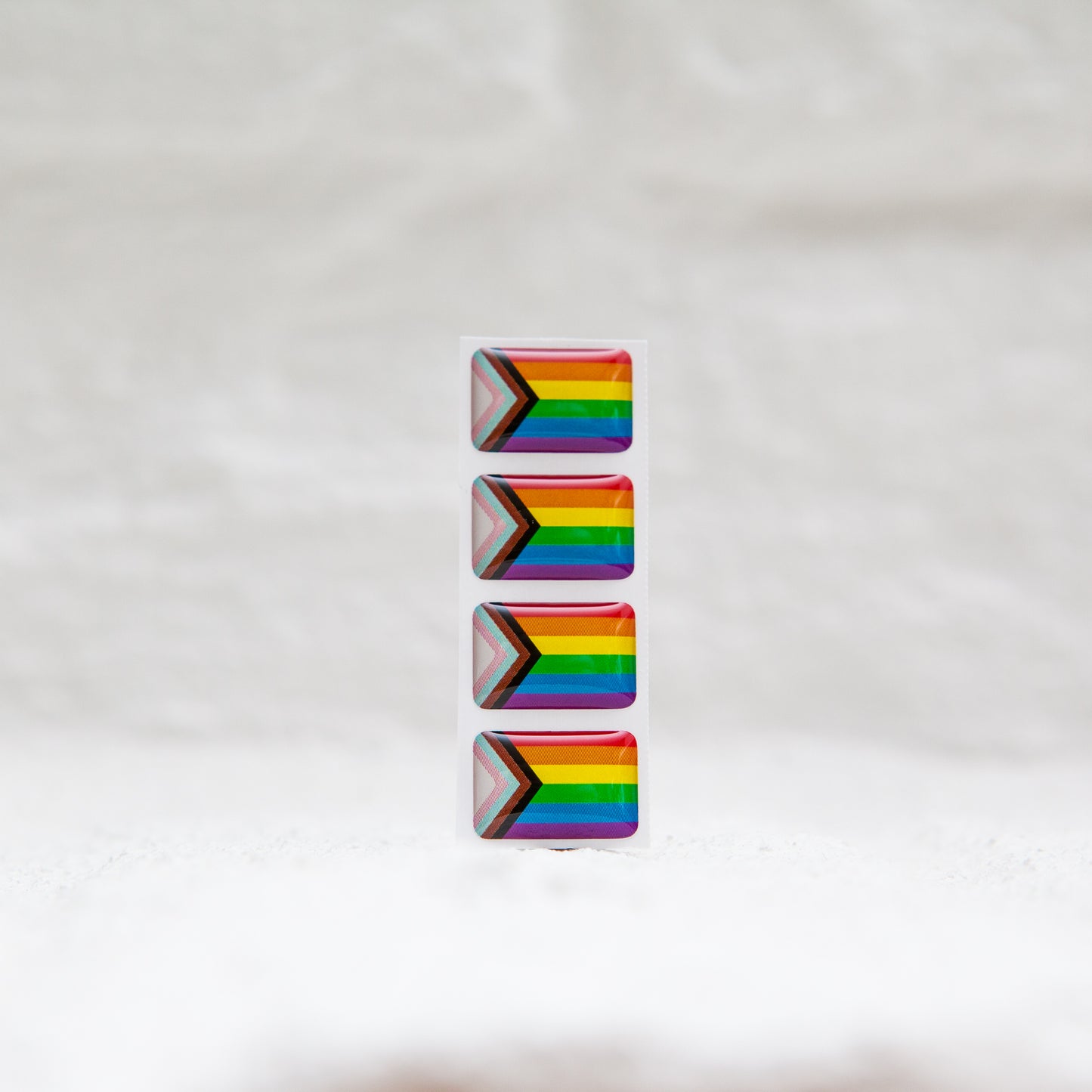 A Progress Pride Flag sticker designed for name badges and ID tags, representing the LGBTQIA+ community. A high-quality, durable gay pride LGBT sticker for inclusivity.