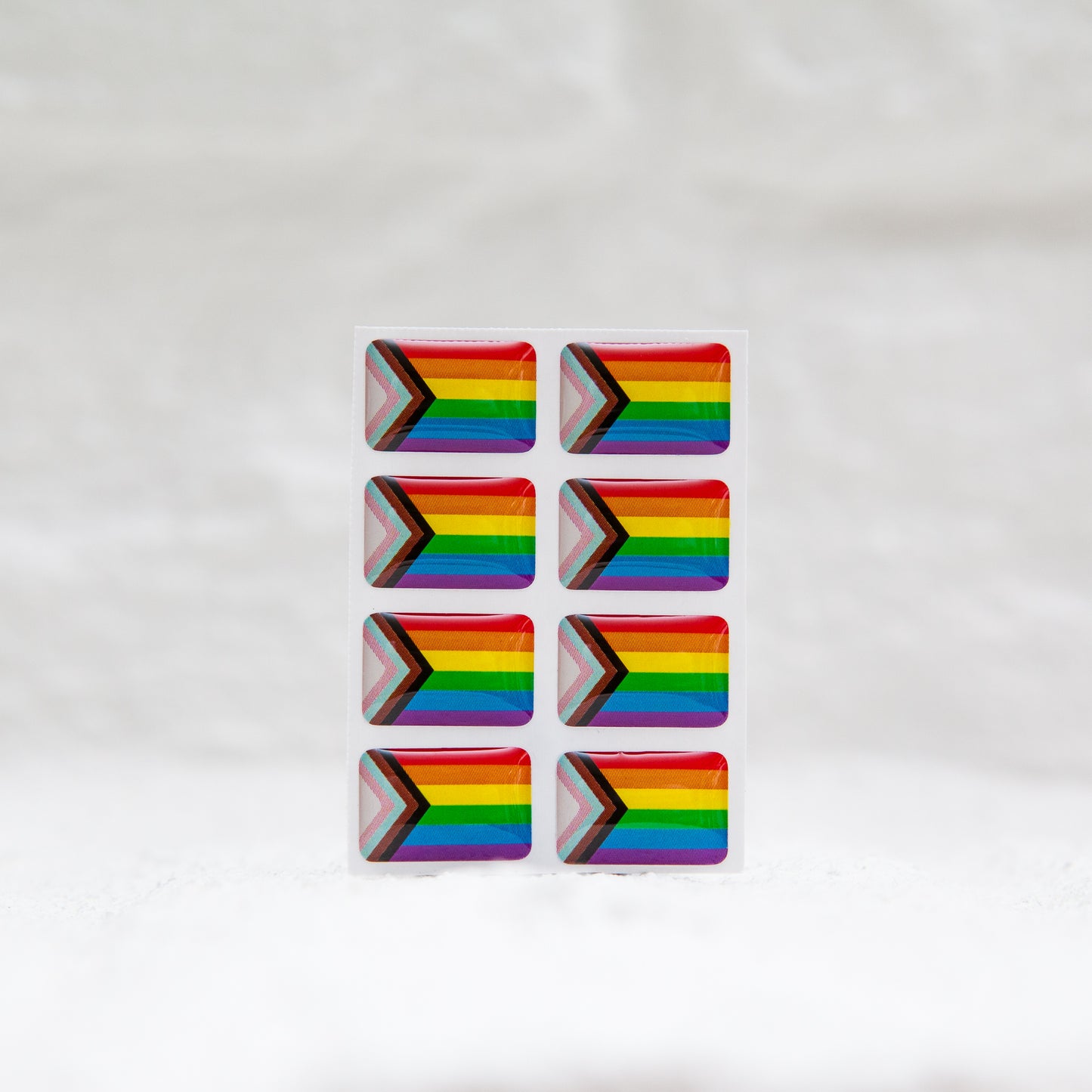 A Progress Pride Flag sticker designed for name badges and ID tags, representing the LGBTQIA+ community. A high-quality, durable gay pride LGBT sticker for inclusivity.