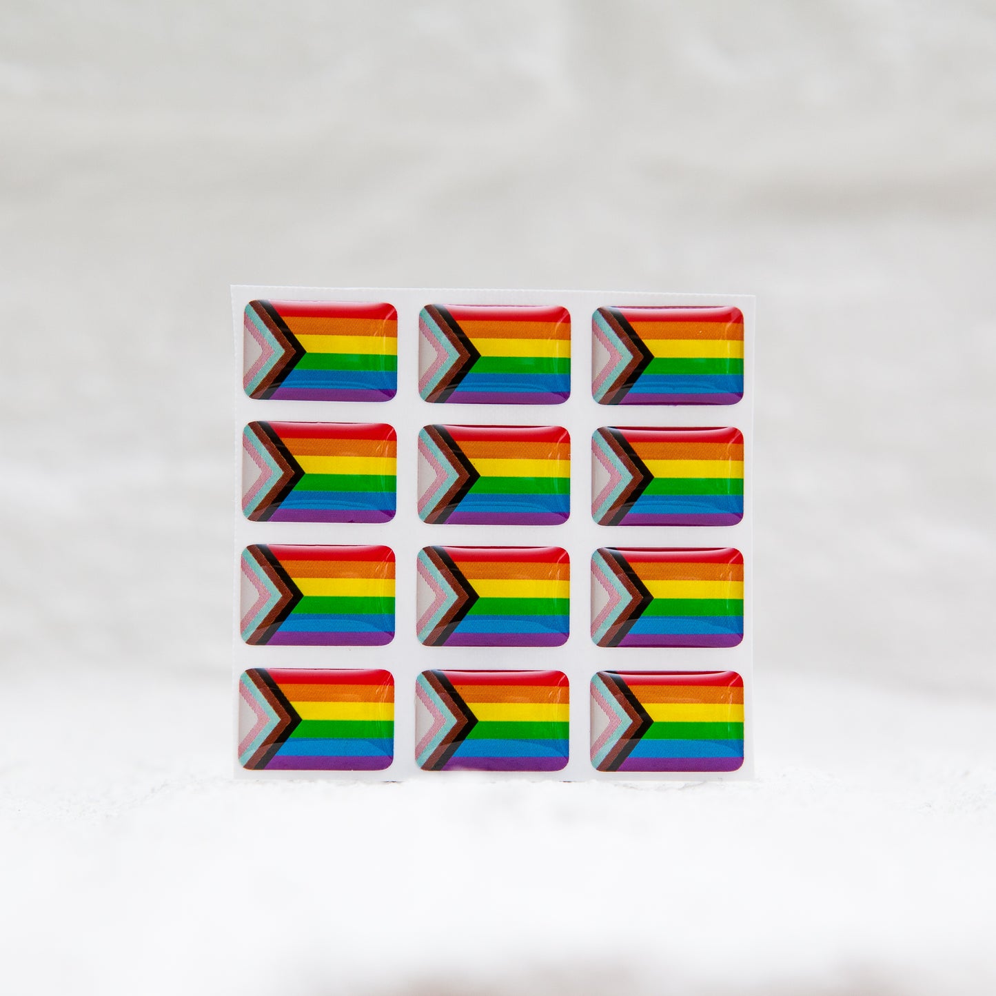 A Progress Pride Flag sticker designed for name badges and ID tags, representing the LGBTQIA+ community. A high-quality, durable gay pride LGBT sticker for inclusivity.