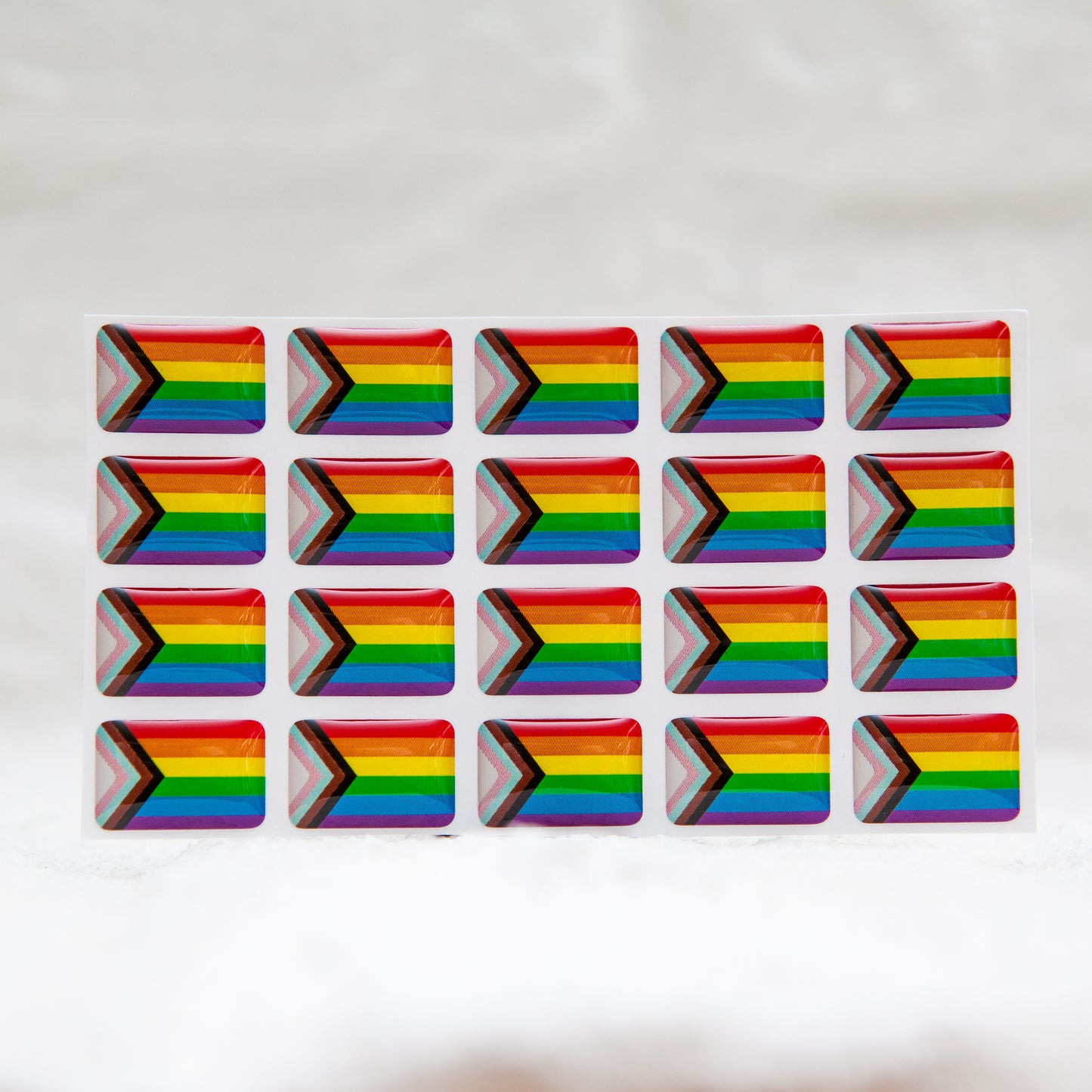 A Progress Pride Flag sticker designed for name badges and ID tags, representing the LGBTQIA+ community. A high-quality, durable gay pride LGBT sticker for inclusivity.