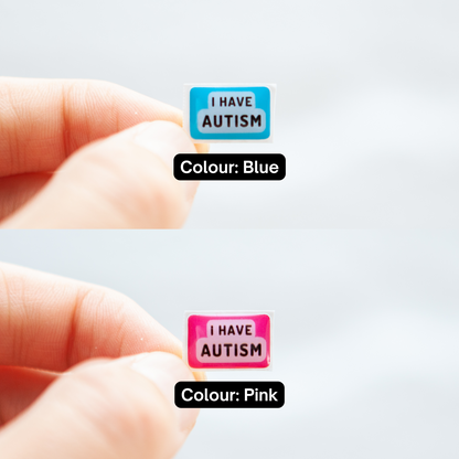 A high-quality autistic sticker with bold text saying "I Have Autism" in pink or blue, designed for name badges and ID badges, promoting autism awareness and inclusivity.